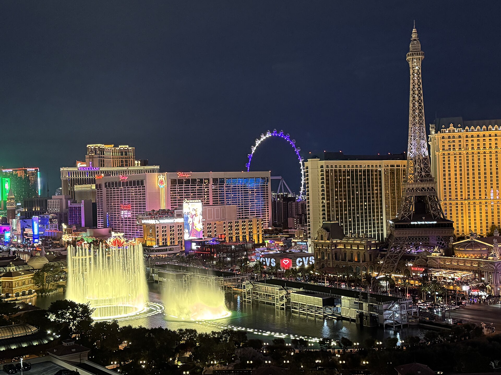 Neon lights and traffic streaking along the Las Vegas Strip at night